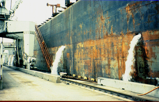 Large vessel unloads ballast water after it arrives at shore.