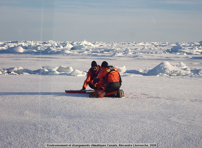 Edmand and Mike leave the helicopter to measure the thickness of the ice.