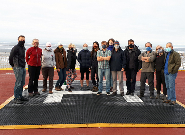 Science crew gathered on the helideck for the mask unveiling.