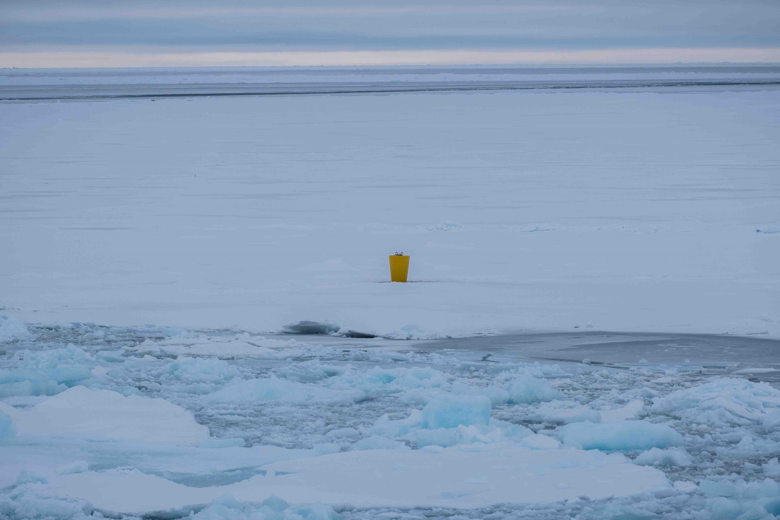 The first ITP deployed during this expedition. The yellow buoy houses a surface package with a satellite link to relay the data to shore. The sensors are suspended below the buoy into the ocean below. (Photo by Elizabeth Bailey).
