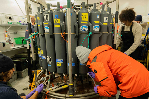Members of the CTD watch team taking samples from the Rosette bottles (photo by Ashley Arroyo).