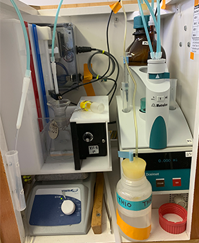 Erinn’s workstation, which includes the auto-titrator, the dissolved oxygen sample (in the clear flask on the left), the bottle of thiosulphate (labeled), and more (Photo by Ashley Arroyo).