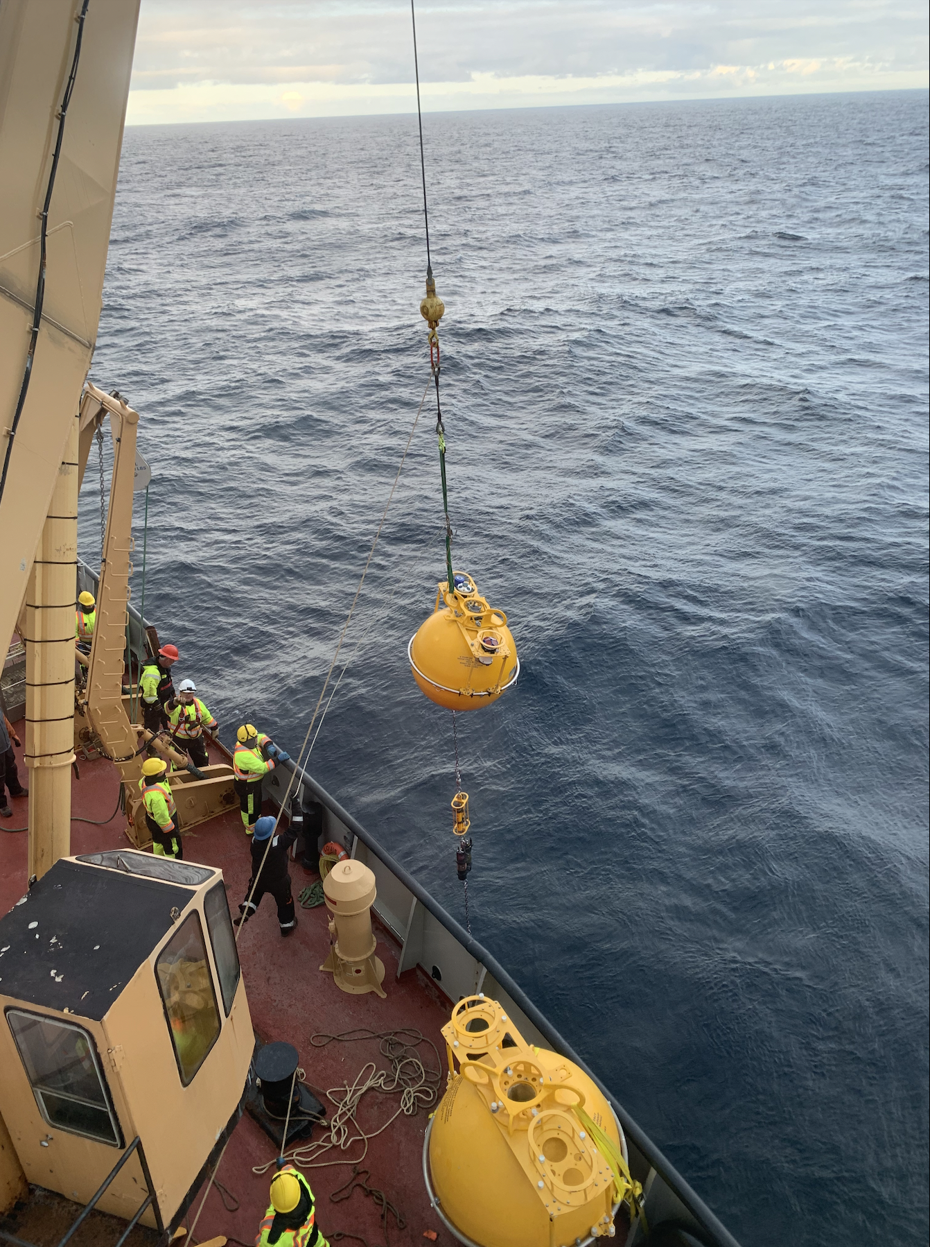 The surface buoy being lowered into the water. (The final step!)
