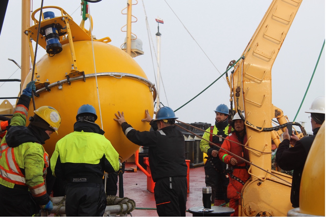 Jeff O’Brien and the mooring team preparing to deploy the flotation sphere for Mooring A (Photo by Paul Macoun)