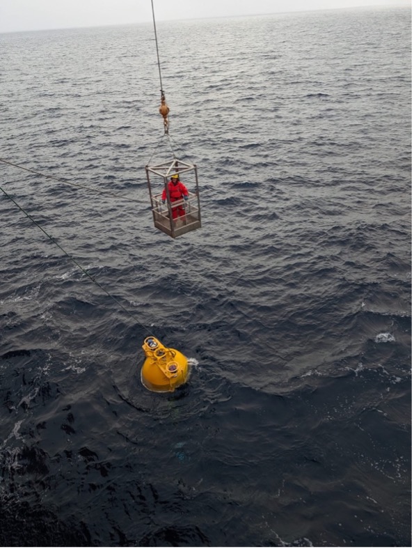 Deckhand Jerome Sibley hooks the surface float from the basket (Photo by Mary-Louise Timmermans)