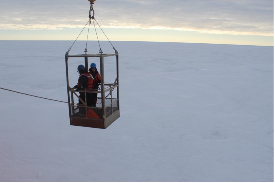 Mary-Louse Timmermans and Jeff O’Brien lowered to the ice to begin the ice survey (Photo by Paul Macoun) 