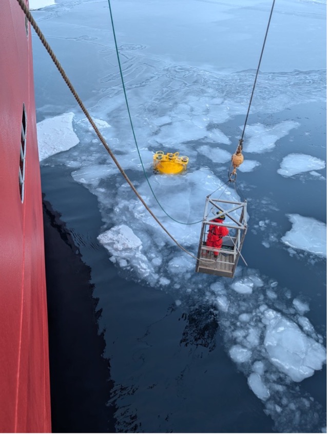 Jerome Sibley prepares to hook the top sphere of the mooring.