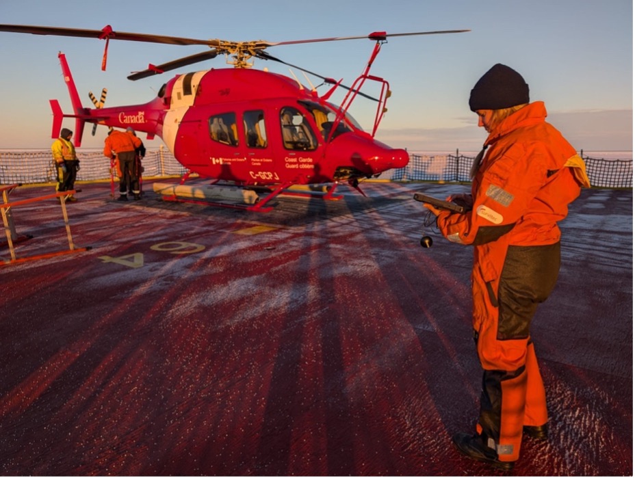 Ice specialist Alexandra Cournoyer prepares for an ice reconnaissance flight in the helicopter (Photo by Mary-Louise Timmermans)