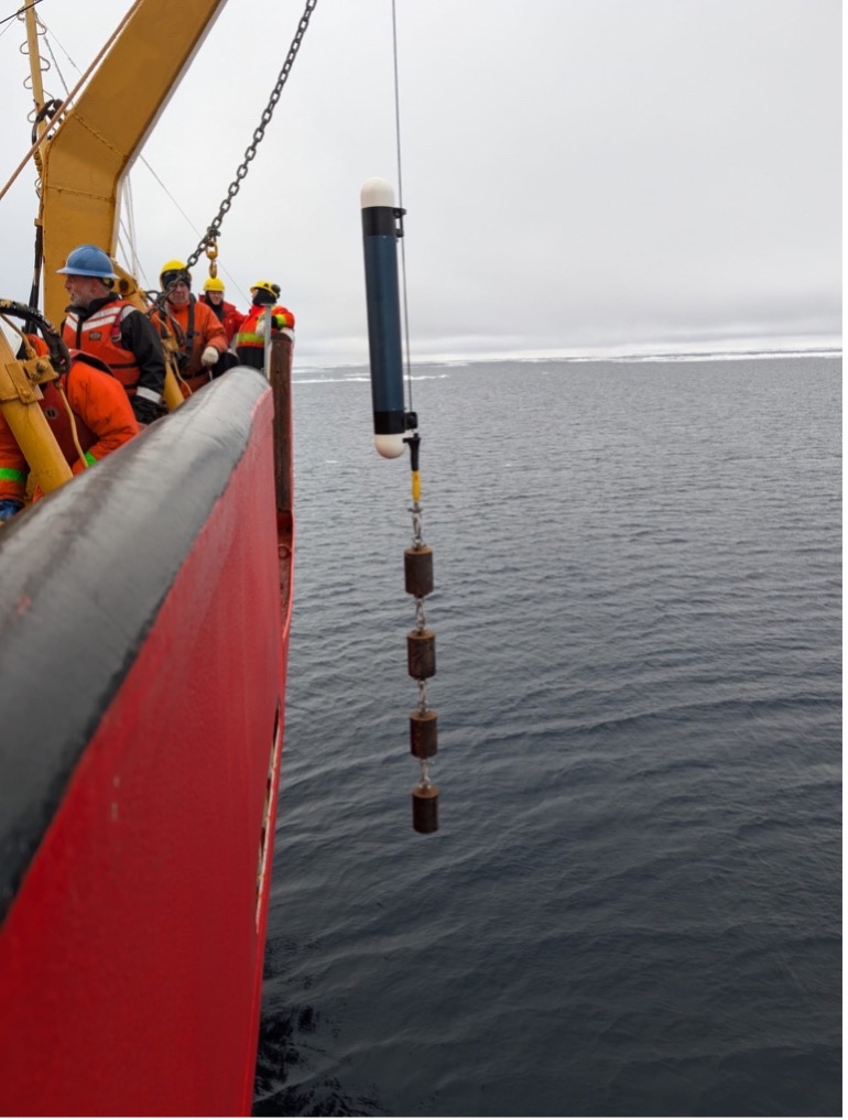 The TOP profiling unit and weights suspended over the side of the ship