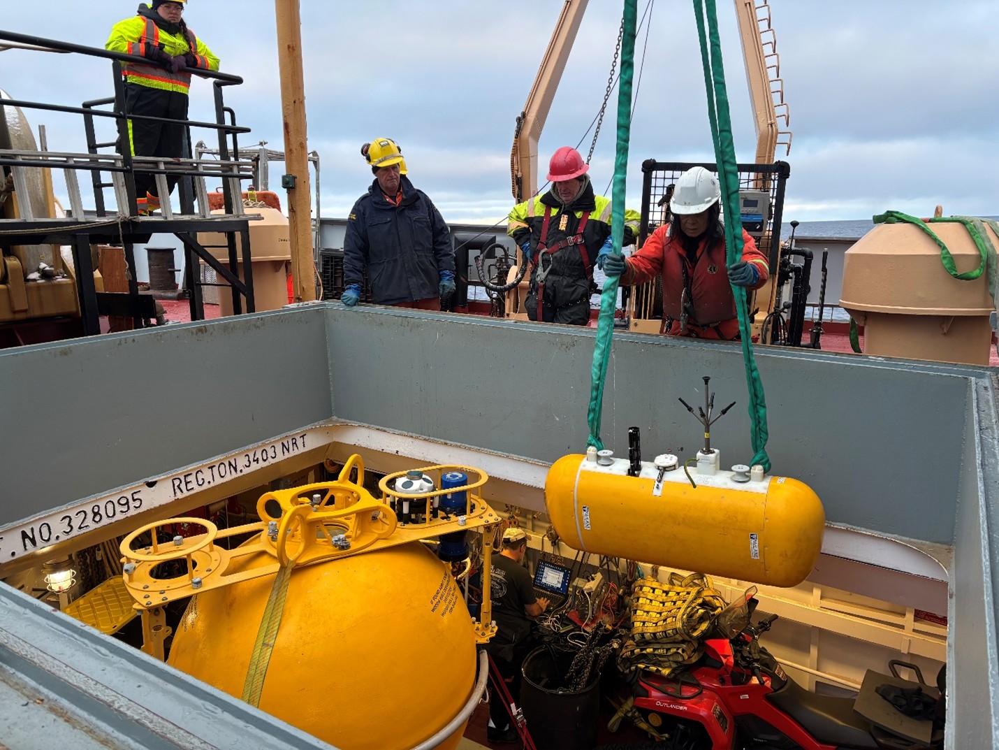Photo 3: Boatswain Rico Amamio lowering one of Mooring A’s McClane Moored Profilers (MMPs) into the forward hold. 
