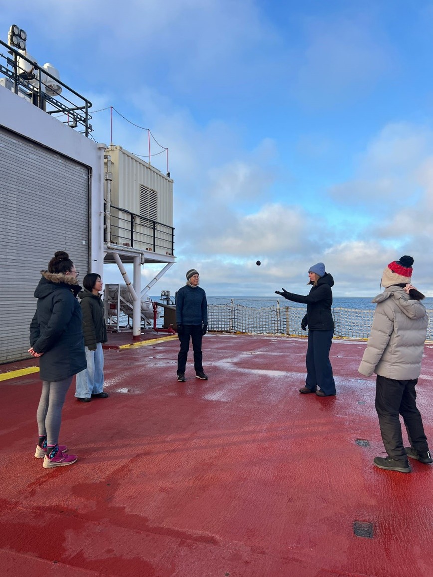 Photo 6: (left to right) Sarah-Ann Quesnel, Yuanxin Zhang, Sarah Zimmermann, Dominique Baker, and Tsukushi Komura playing hacky sack on the helipad. Photo by Annabel Payne. 