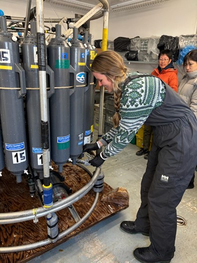 Photo 2: Paige Hagel collecting a salinity sample. 