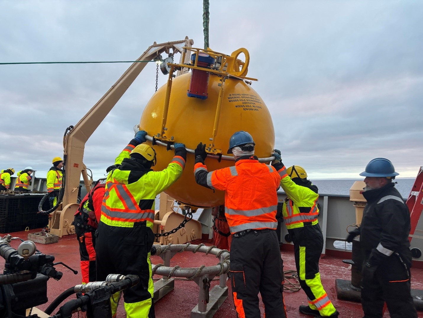 Photo 2: The BGOS team and Louis deck crew helping to position Mooring D’s top sphere on deck. 
