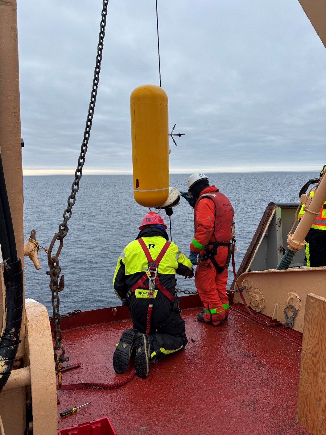 Photo 4: WHOI technician Jim Ryder and boatswain Rico Amamio bringing one of Mooring D’s McClane Moored Profilers (MMPs) on deck.  