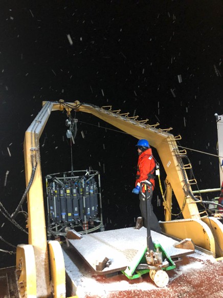 Photo 5: Night watch leader Paige Hagel bringing the CTD rosette back on deck after a snowy cast at CB-19. Photo by Marguerite Larriere. 