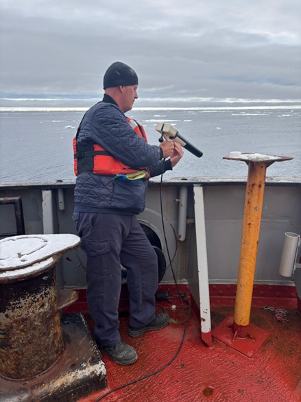 Photo 5: Crewmember Roger Carew deploying an xCTD sensor from the stern of the Louis.