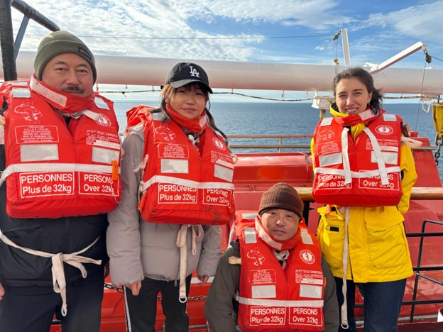 Members of the science team (left to right: Takuji Waseda, Tsukushi Komura, Kazu Tateyama, Marguerite Larriere) posing after the ship-wide fire drill. 