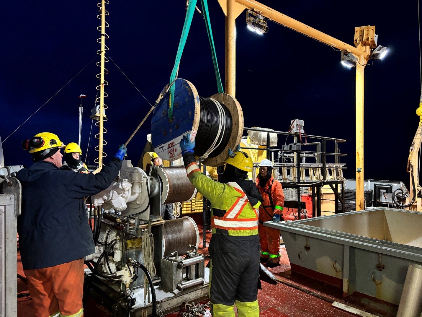 Photo 1: The deck crew unloading spools of wire from the forward hold in preparation for Mooring A’s deployment. 