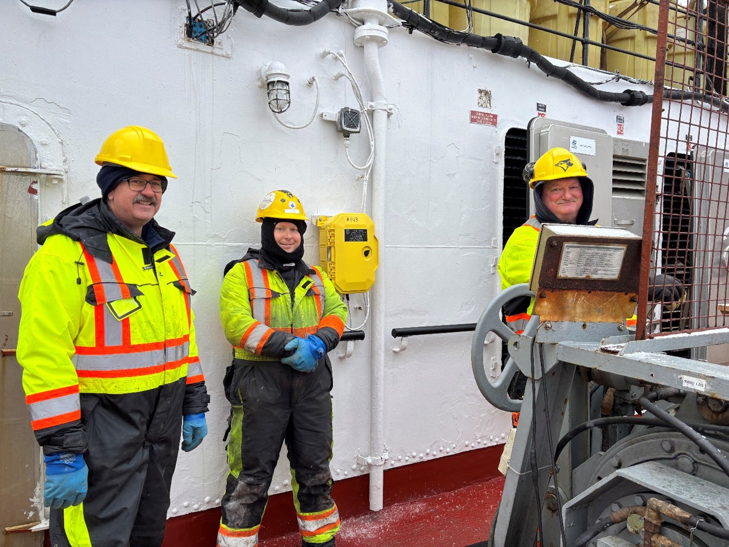 Photo 4: (left to right) Robert Butt, Devon Fitzpatrick, and Jerome Sibley operating the CTD winch. 