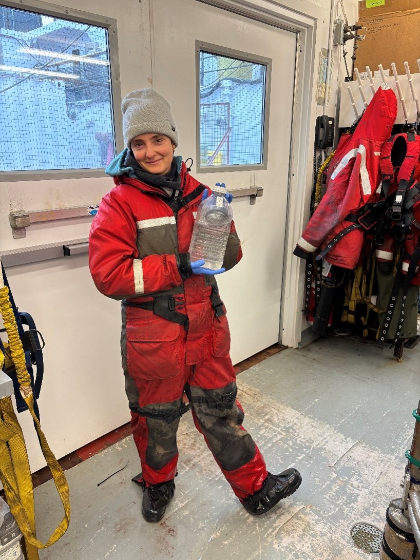 Photo 5: Annabel Payne posing with a cranberry juice bottle that was used to collect iodine samples. 