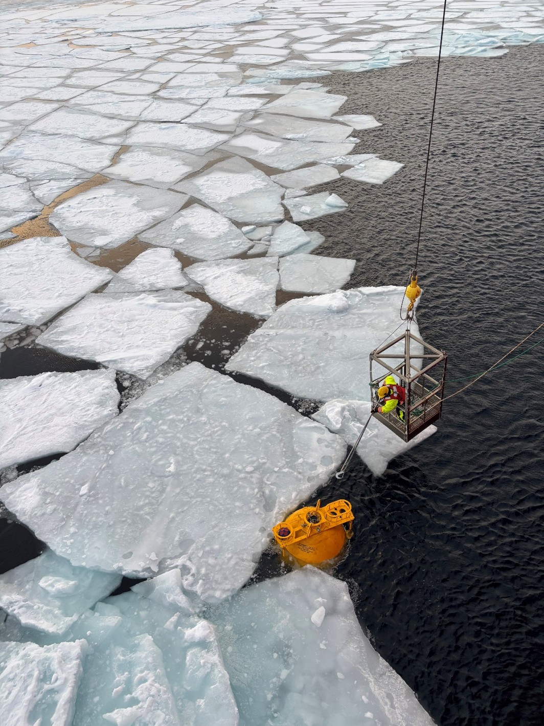 Photo 1: Deckhand Jerome Sibley clipping Mooring B’s top sphere into the winch. 