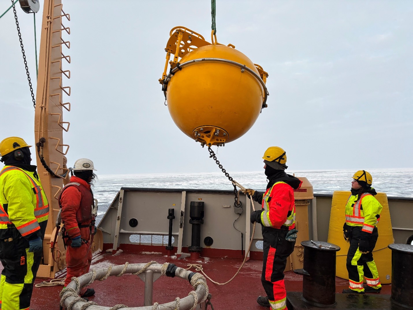 Photo 2: Deckhand Colin Kavanagh guiding Mooring B’s top sphere on deck. 