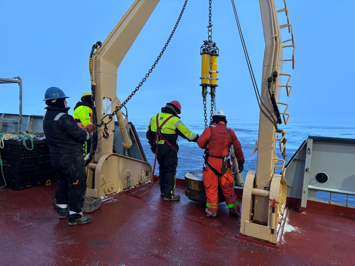 Photo 3: (left to right) Jeff O’Brien, Jim Ryder, and boatswain Rico Amamio preparing to deploy Mooring B’s base, which includes a set of acoustic releases, a bottom pressure recorder, and an anchor. 