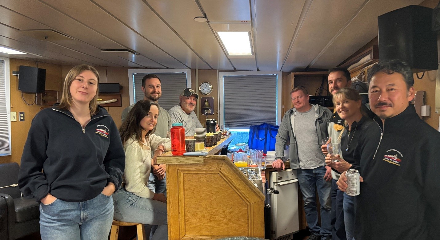Photo 5: Members of the science team and ship’s crew enjoying Friday night’s happy hour. 