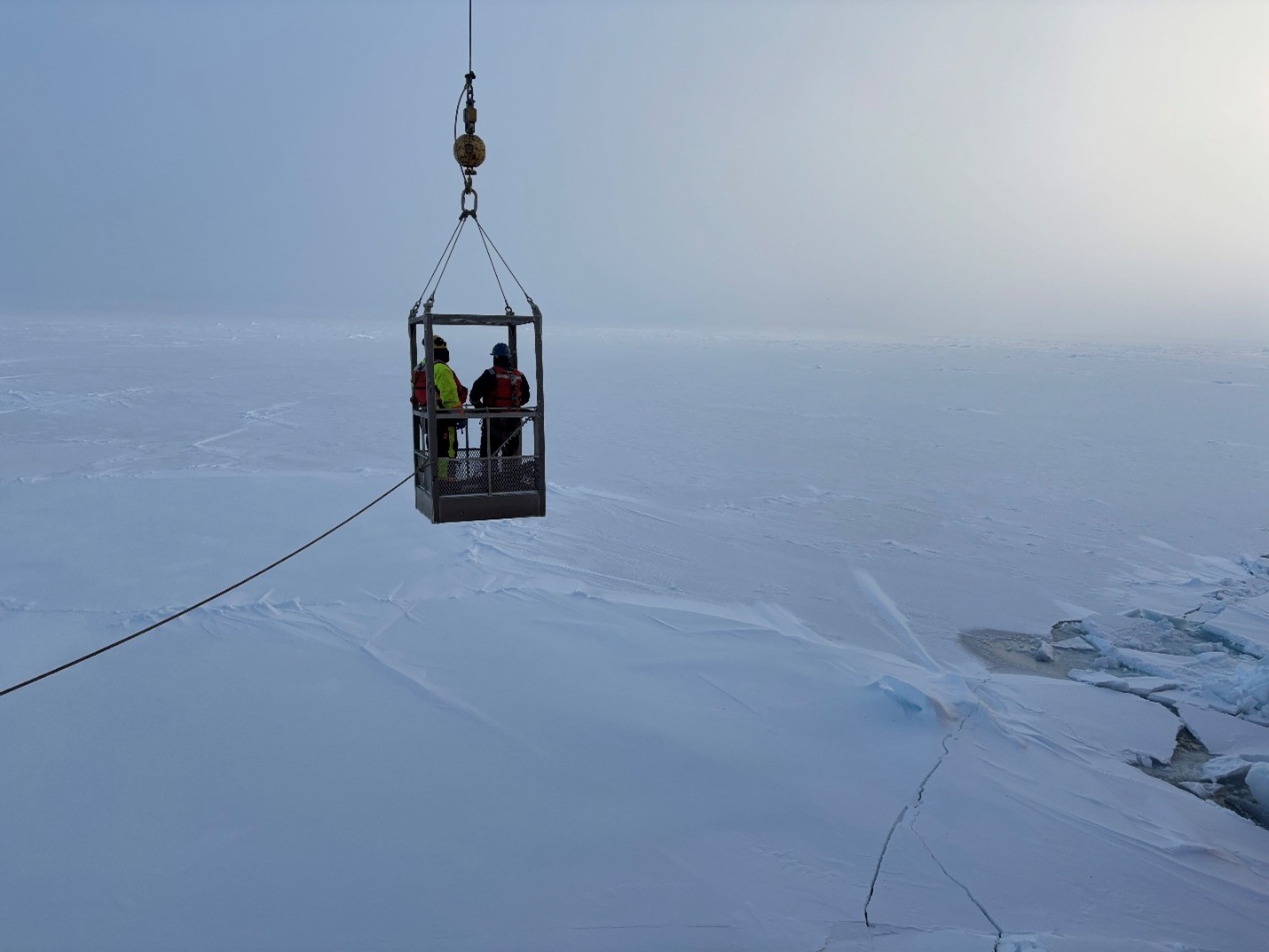 Photo 1: Jeff O’Brien and Jerome Sibley being lowered in the man-basket to an ice floe. 
