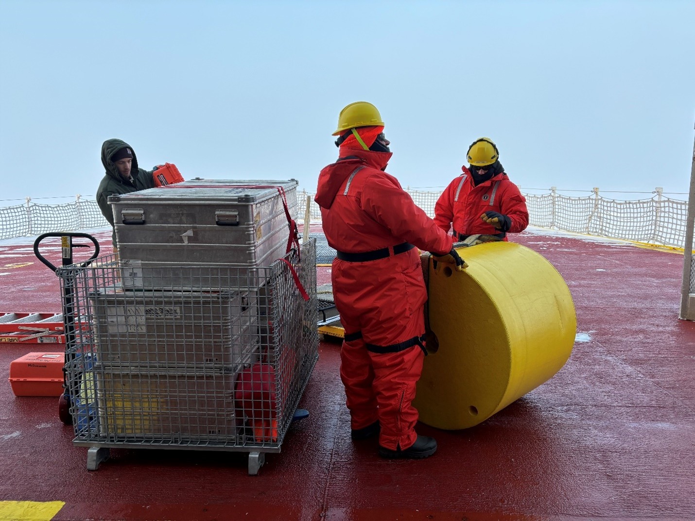 Photo 2: (left to right) Tim McDonough, Paul Fifield, and Andrew Peddle preparing equipment for the TOP deployment. 