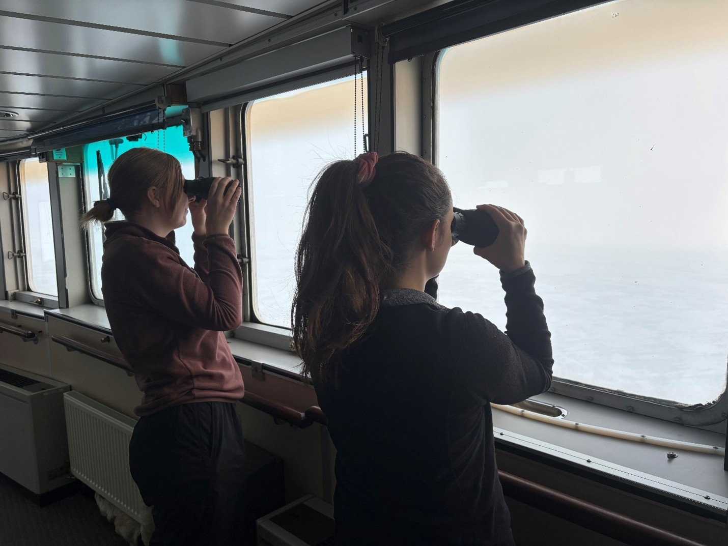 Dispatch18Photo1 Photo 1: Dominique Baker (left) and Annabel Payne (right) looking for polar bears from the bridge deck.