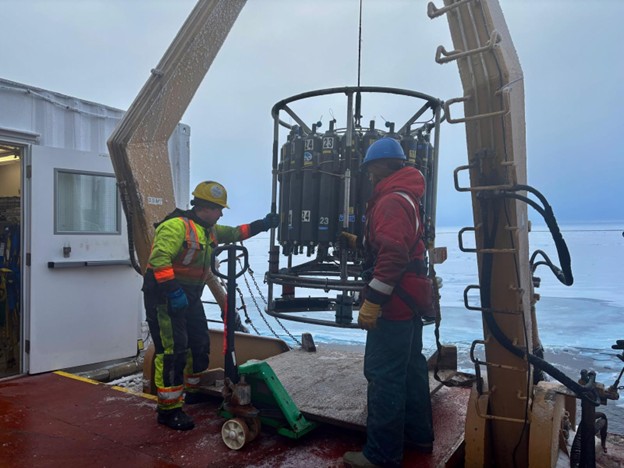 Dispatch19Photo4 Photo 4: Deckhand Devon Fitzpatrick (left) and Chris Clarke (right) bringing the CTD rosette back on board after the cast at CB-13.