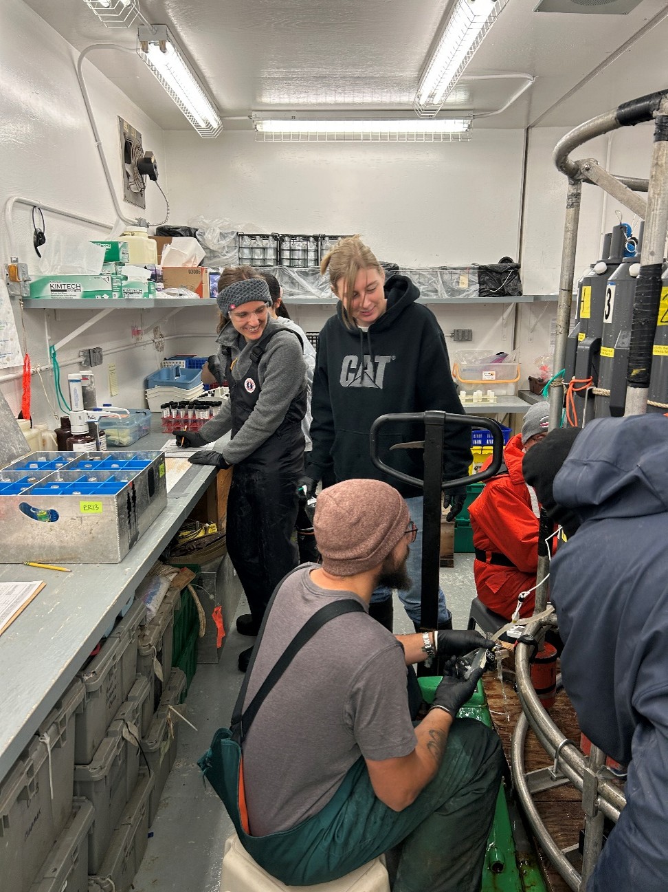 Dispatch29Photo4 Photo 4: Jennifer Kosty (left) and Dominique Baker (right) helping Chris Clarke draw dissolved oxygen and dissolved inorganic carbon (DIC) samples. Photo by Sarah Zimmermann.