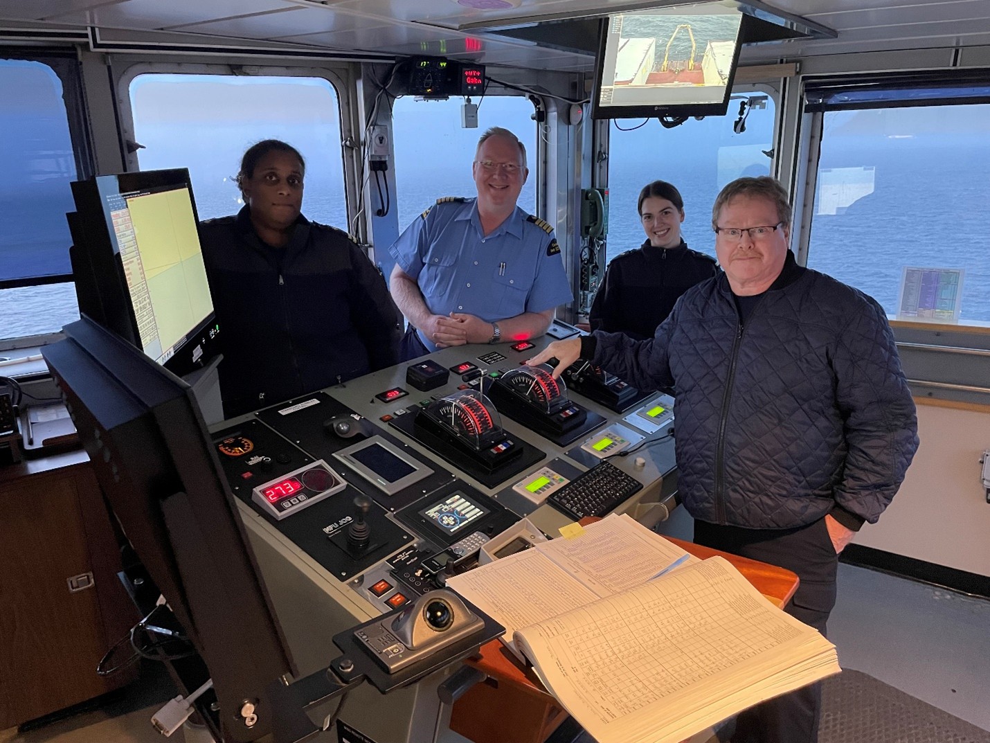 Dispatch34Photo2 Photo 2: Huge thanks to the bridge team! Shown here are (left to right) Second Officer Dominique Rennie, Captain Briggs, Third Officer Alhana Sheppard-Benmansour, and First Officer David Critch. Photo by Paul Macoun.