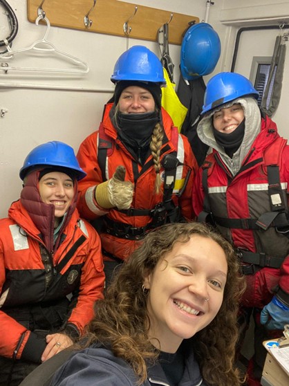 Picture4 Photo 2: The night watch (left to right: Marguerite Larriere, Paige Hagel, Collette Leclerc, and Magali Pucet) warming up in the CTD shack during a cold cast. Photo by Collette Leclerc.