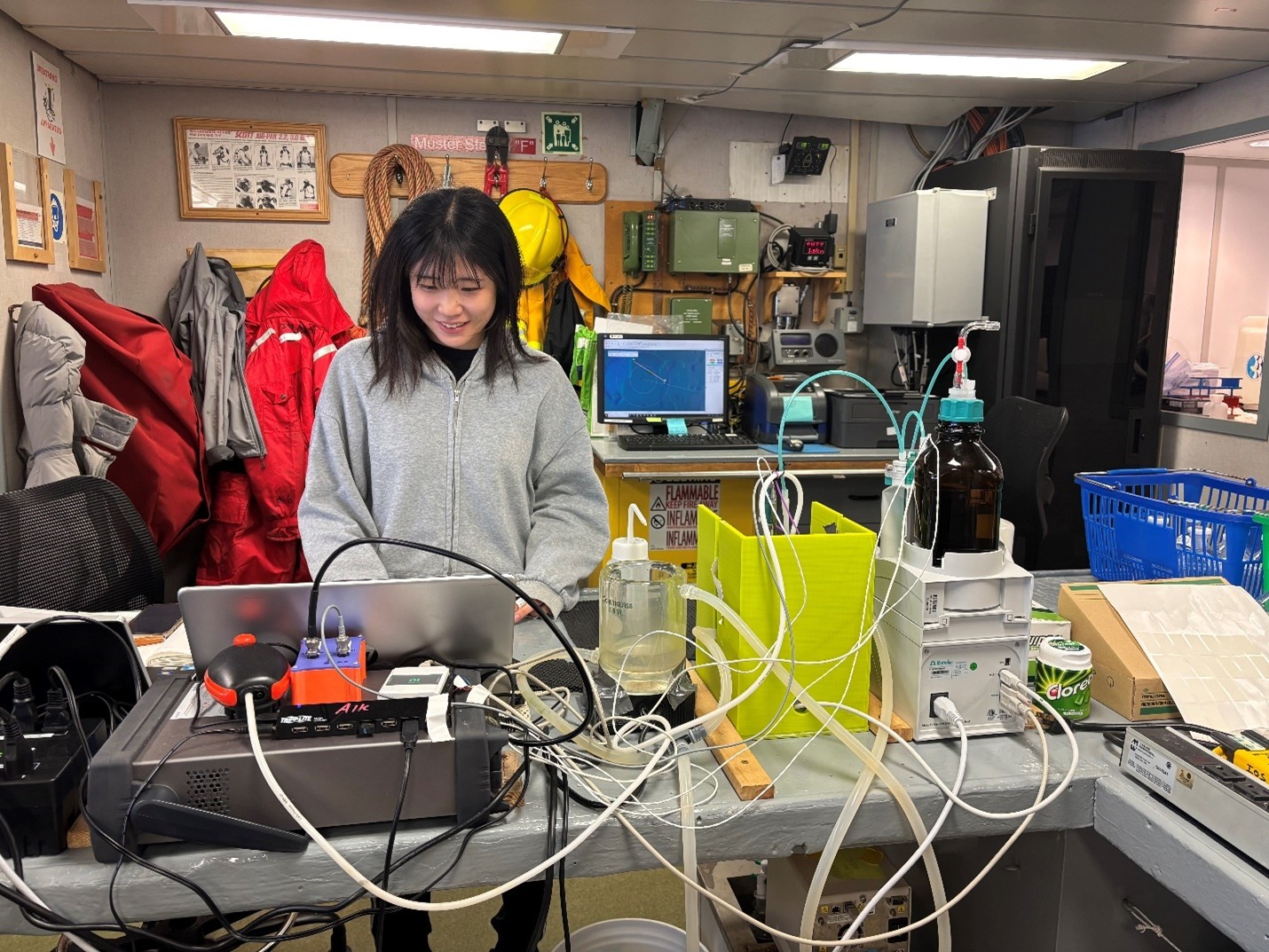 Picture5 Photo 3: Tsukushi Komura processing alkalinity water samples after the cast at PP-5.