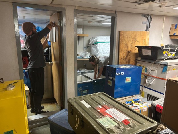 Picture5 Photo 1: Chris Clarke (left) and Paige Hagel (right) organizing equipment boxes that will remain on the Louis.