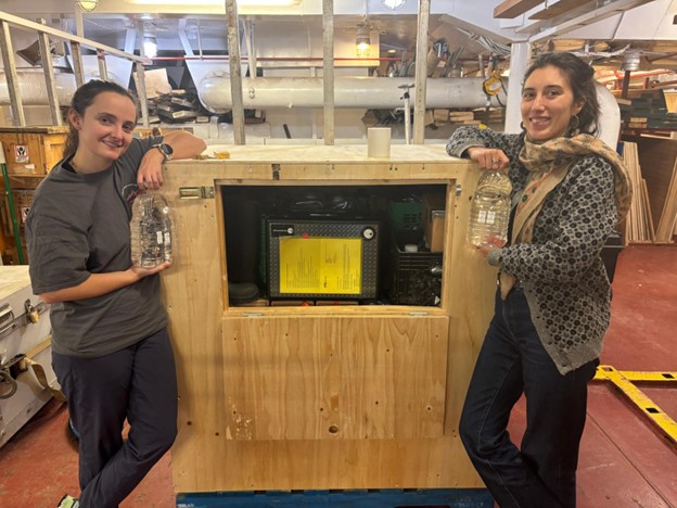 Picture6 Photo 2: Annabel Payne (left) and Marguerite Larriere (right) posing with the iodine/uranium sample storage container (lovingly referred to as “the rabbit hutch”) built for them by carpenter Robert Butt.