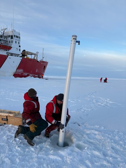 Picture7 Photo 5: Chris Clarke (left) and Paul Macoun (right) deploying a seasonal ice mass balance buoy (SIMB). Photo by Dominique Baker.