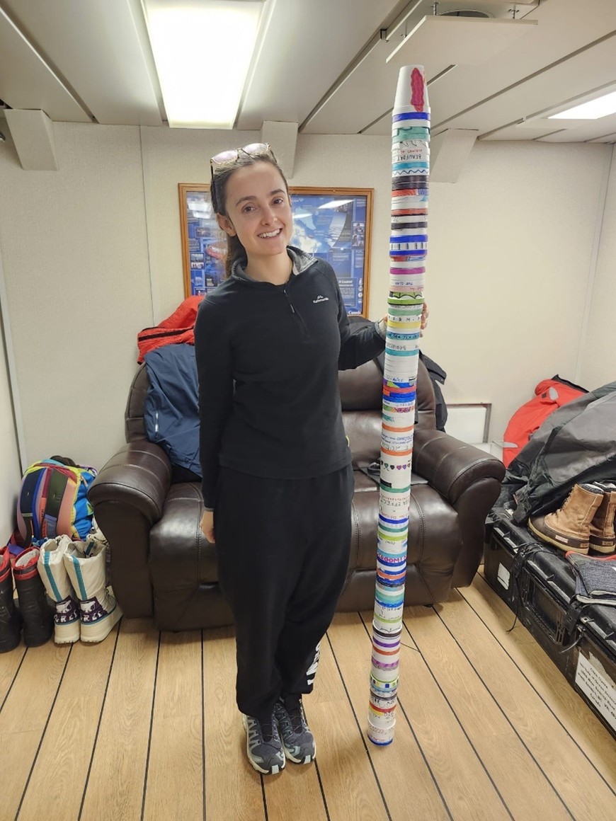 Picture7 Photo 5: Annabel Payne standing next to a tower of decorated “shrinky” cups! Photo by Magali Pucet.
