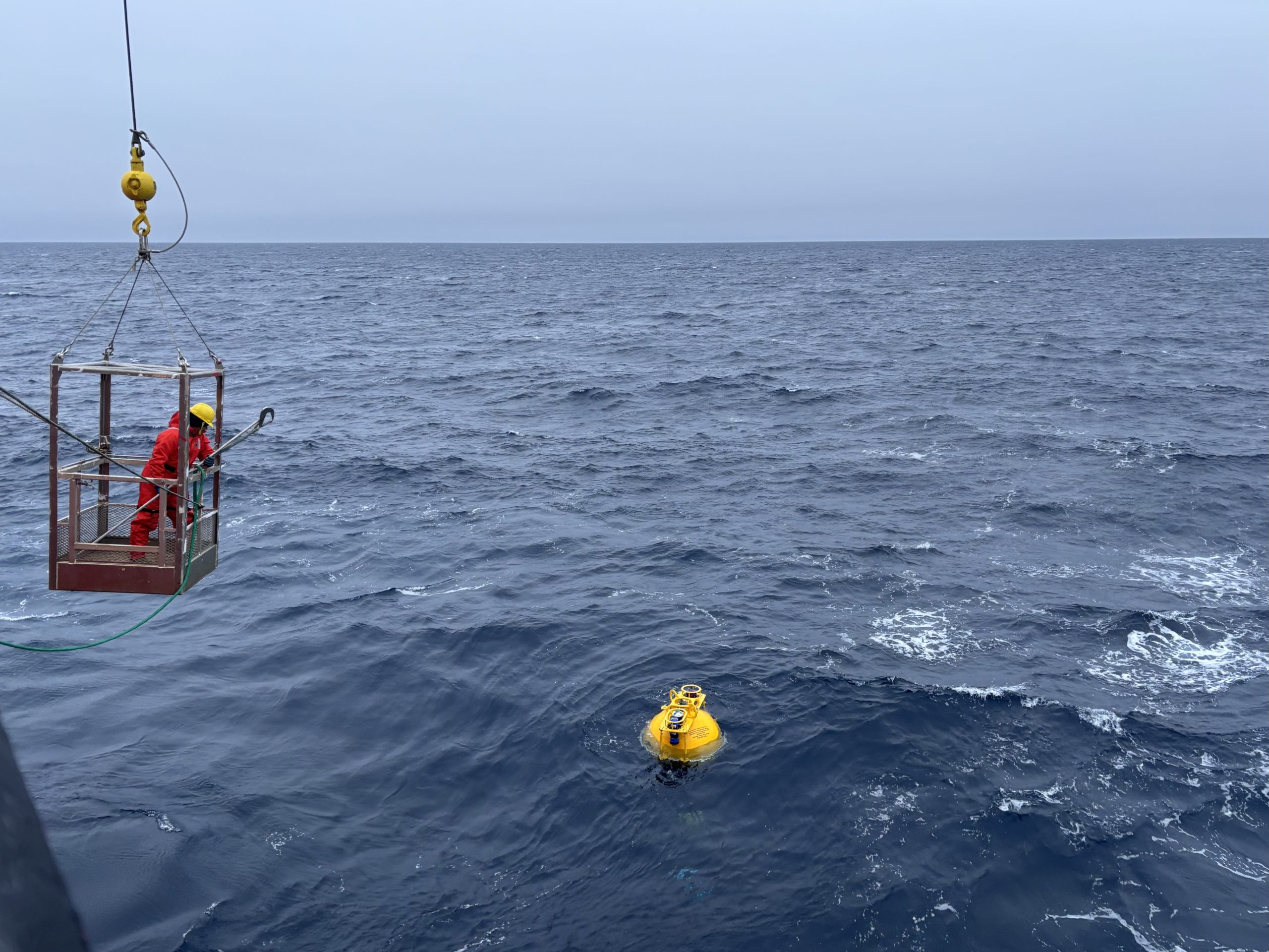 Chesley, a member of the deck crew, hooking Mooring D’s top sphere into the winch. Photo by Jennifer Kosty. 