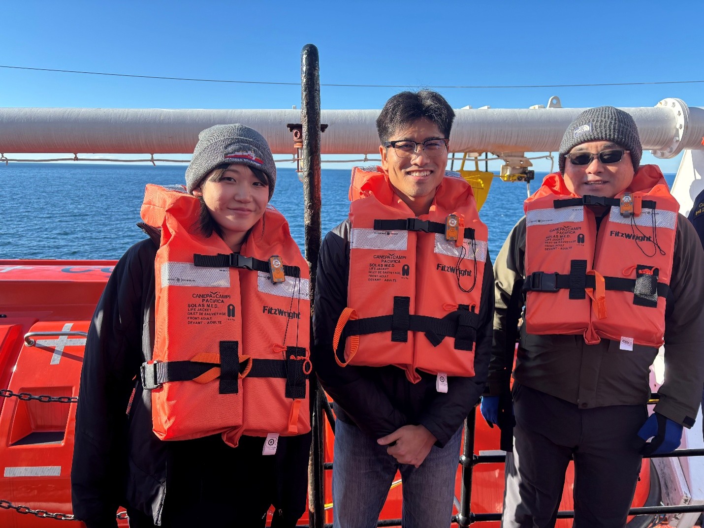 (left to right) Tsukushi Komura, Hayate Kato, and Kazu Tateyama during the ship-wide emergency drill. Photo by Jennifer Kosty.