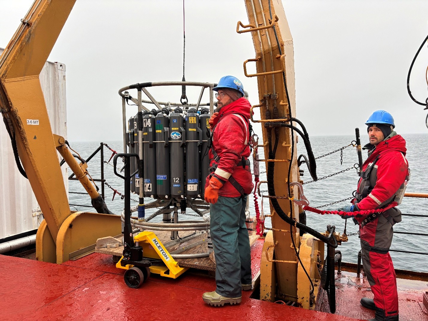 Chris Clarke (left) and Clement Feriot (right) deploying the CTD-rosette at AG5. Photo by Jennifer Kosty. 