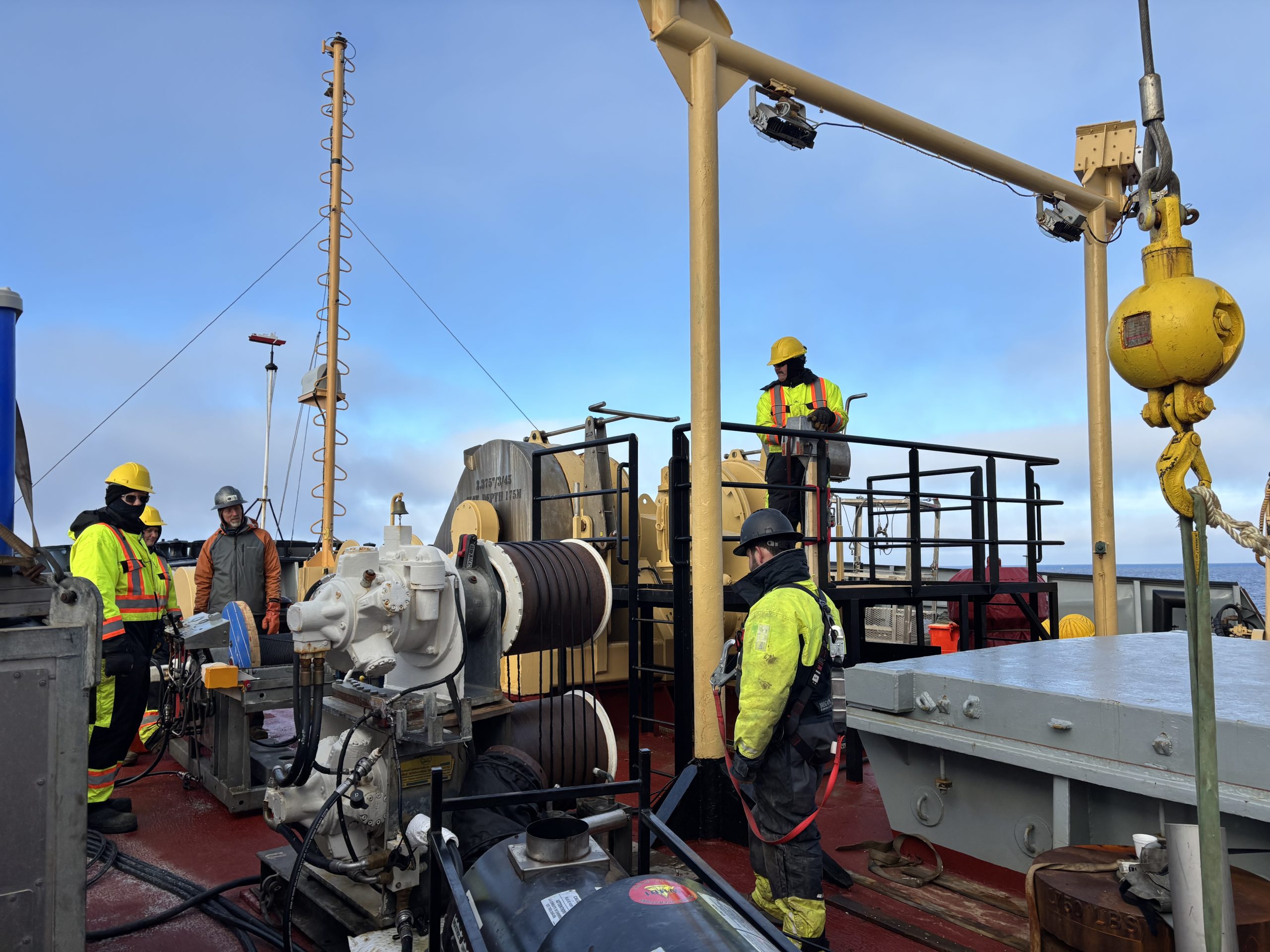 Chris Basque and the deck crew monitoring the mooring wire as it is reeled out. Photo by Jennifer Kosty. 