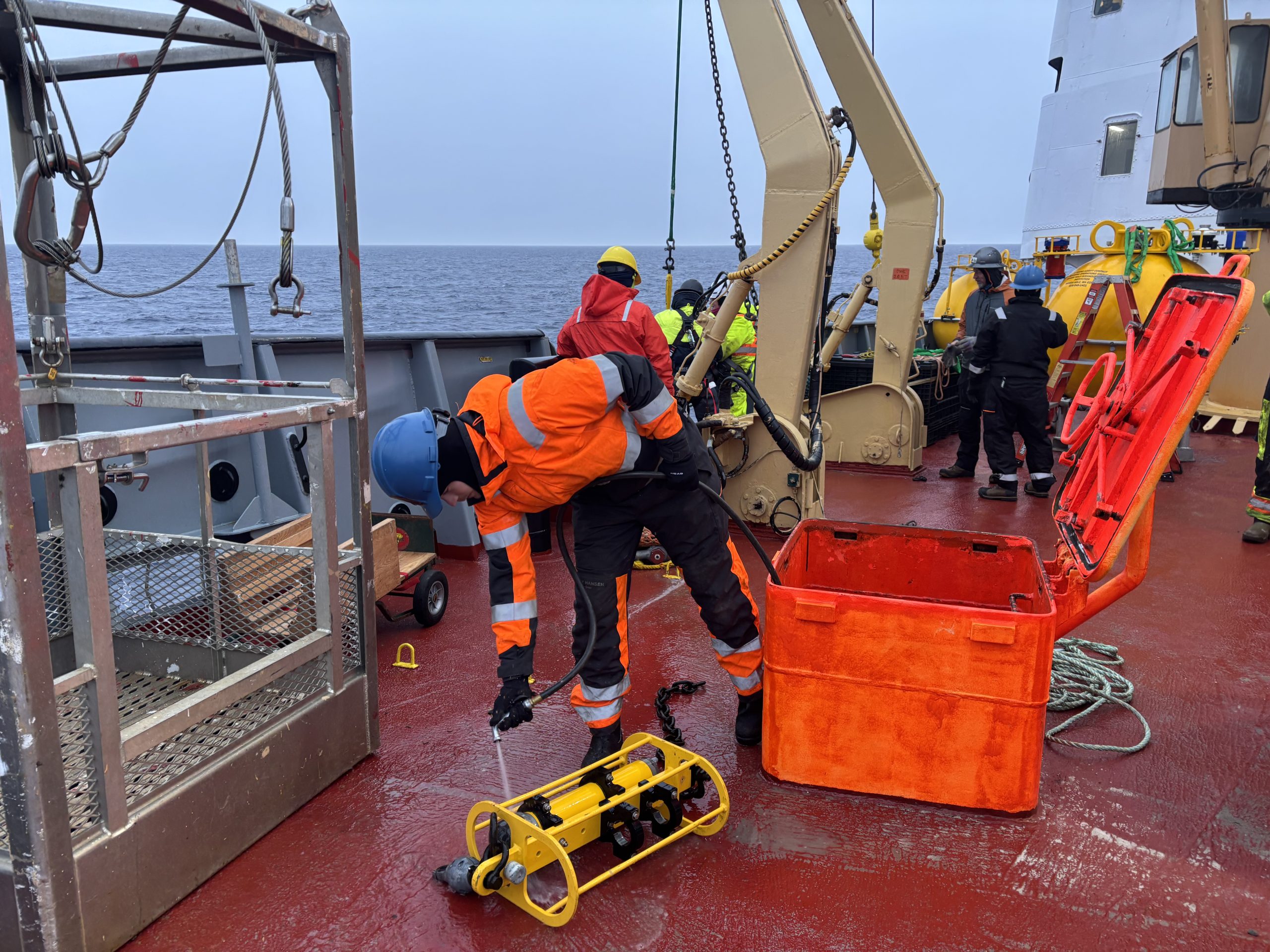 Tim McDonough rinsing one of Mooring D’s instruments after its recovery. Photo by Jennifer Kosty. 