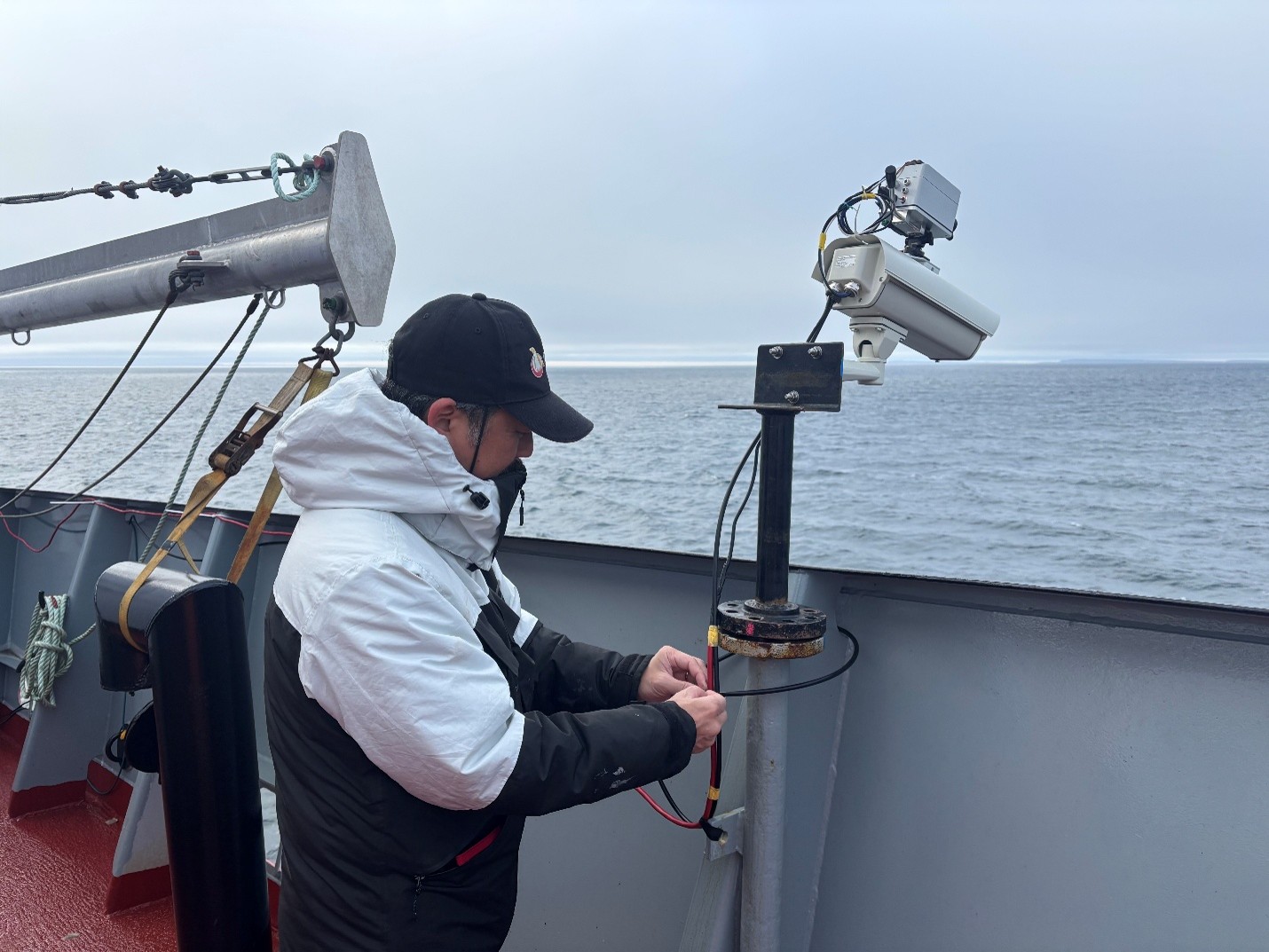 Takuji Waseda setting up an infrared camera for measuring sea ice thickness. Photo by Jennifer Kosty. 