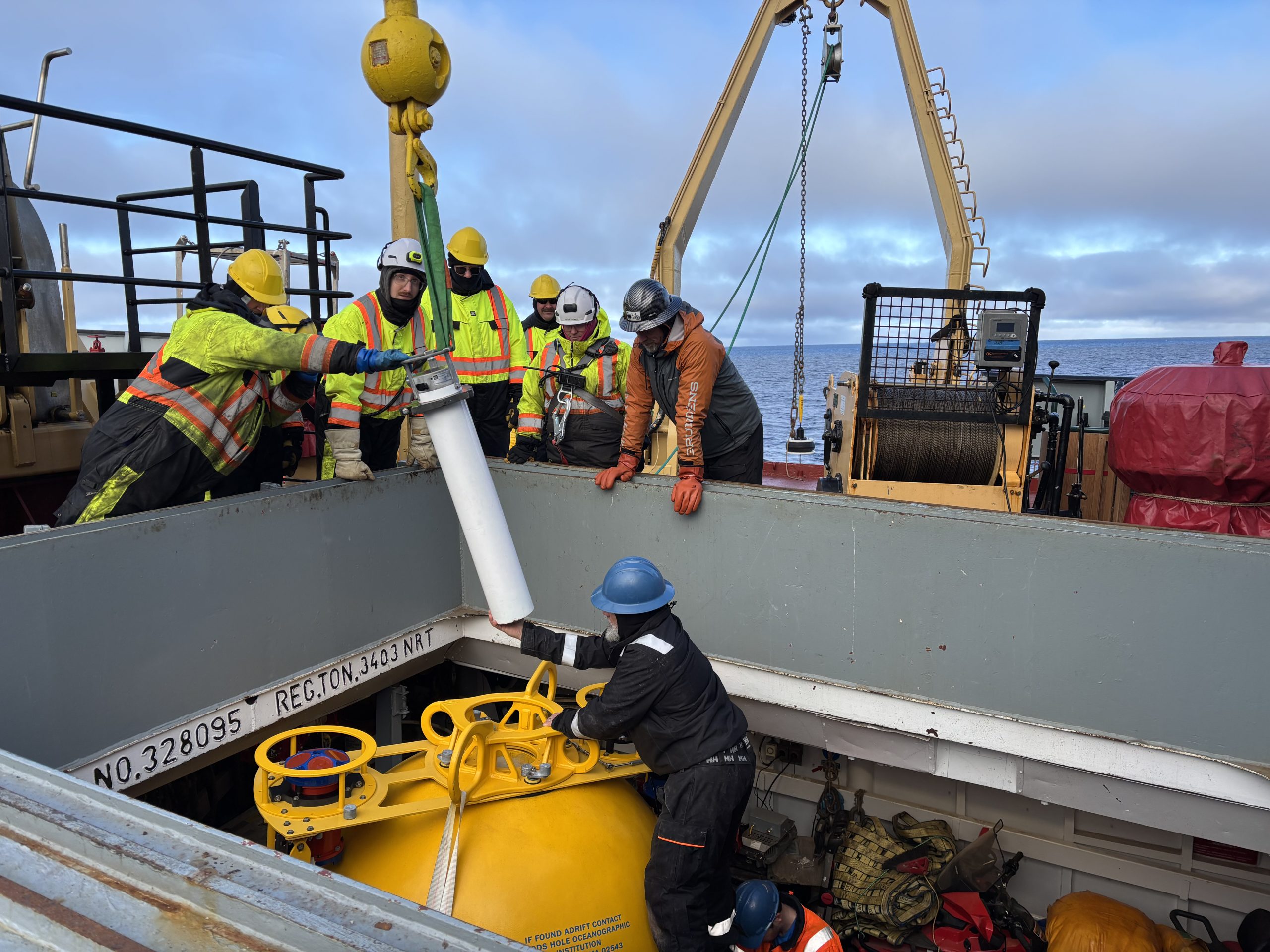 Jeff O’Brien installing an upward looking sonar (ULS) into Mooring D’s top sphere. Photo by Jennifer Kosty. 