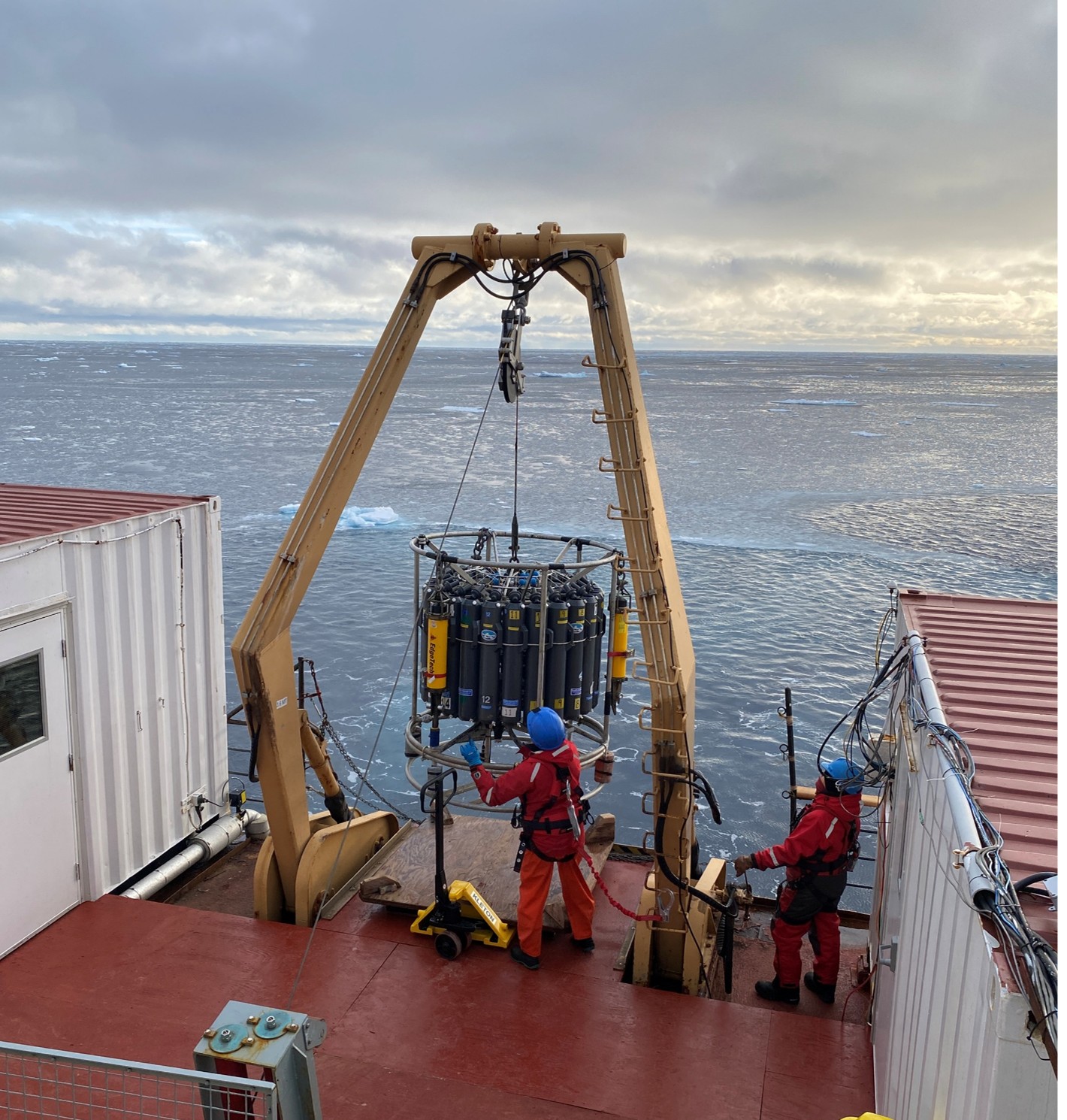 The day watch deploying the CTD-rosette with acoustic releases mounted on its frame (yellow instruments). The WHOI team used the CTD-rosette cast to test the releases prior to their upcoming deployment on the BGOS moorings. Photo by Monika Loevenmark. 