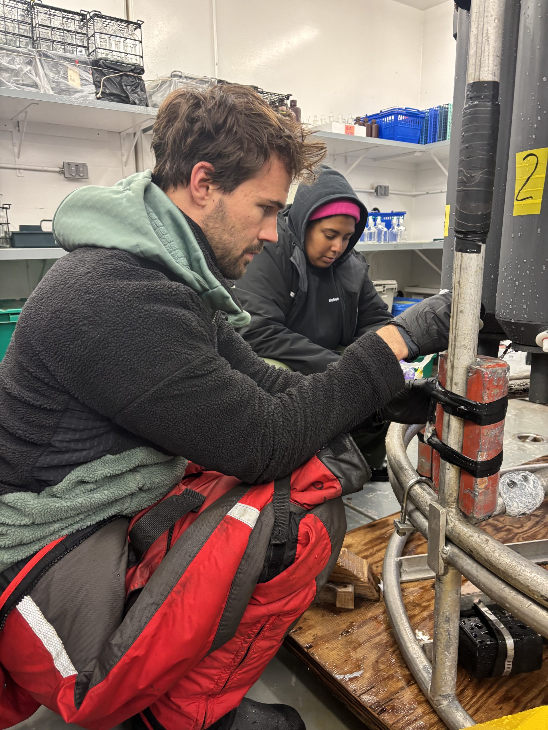 Clement Feriot (left) and Lauren Bannerman-Maxwell (right) drawing water samples at CB1. Photo by Jennifer Kosty.
