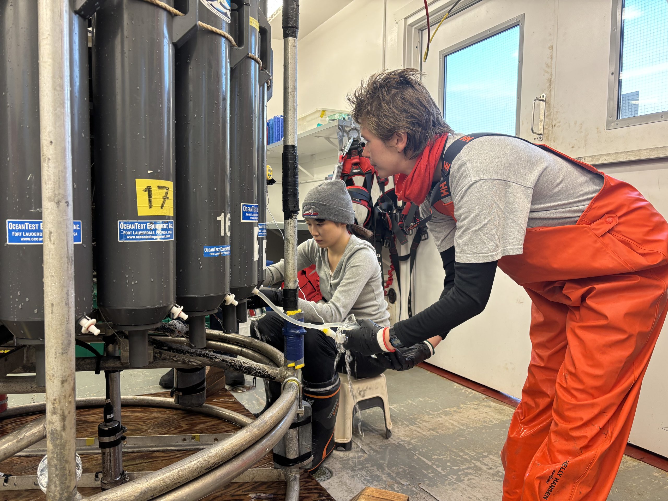 Tsukushi Komura (left) and Chloe Immonen (right) drawing water samples. Photo by Francesca Loro.  